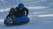 Calgary Snowstorm Aftermath: Students Toboggan While Drivers Scramble for Tires