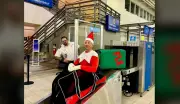 Festive Elf Spreads Holiday Cheer at Moncton Airport During Busy Travel Season