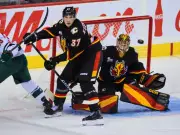 Flames Triumph Over Wild 4-1: Wolf's 26 Saves & Huberdeau's Drought Ends