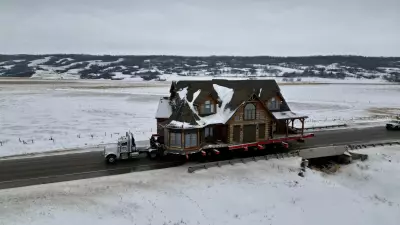 Massive Log Home Nears Journey's End After Epic Transport from Lajord