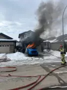 Regina Firefighters Battle Blaze as Truck Burns in Residential Driveway