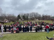Dozens of Manitobans March for Change on Red Dress Day at The Forks