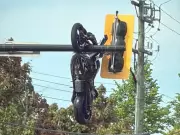Motorcyclist Hospitalized After Crash Leaves Bike Hanging from Traffic Lights