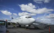 Some airlines cut fuel surcharges as oil prices drop, others hold steady