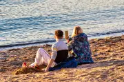 Why You Should Wait to Post Vacation Photos, According to Experts