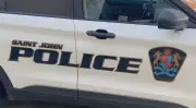 Woman faces drug charges after found slumped over wheel in Saint John